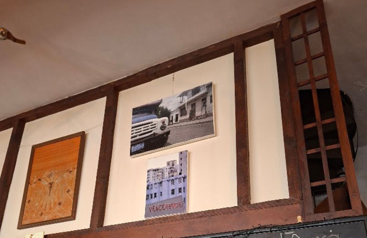 Old photographs and pictures on the walls of a village kafeneio in Arcadia